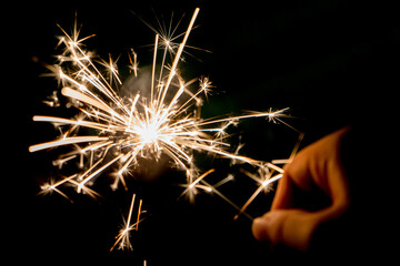 Hand holding firework. Cool lights during the festival.