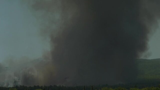 Big fire at Varimbombi, Athens, Greece, August 03, 2021. Black smoke from mega fire covers the sky 120fps