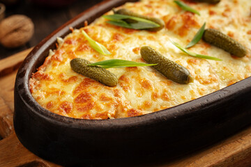 Georgian baked beef stew under cheese with pickles