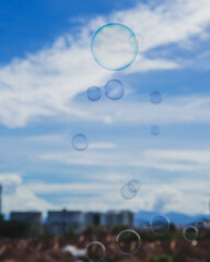 soap bubbles are floating with city background.