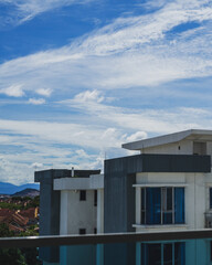 Bangi, Malaysia - July 12, 2021 View looking up at generic apartment buildings and blue sky with clouds in a sunny day.