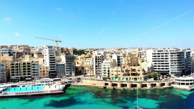 Breathtaking aerial view of St. Julians city, Balluta Bay Beach and buildings of Malta island.