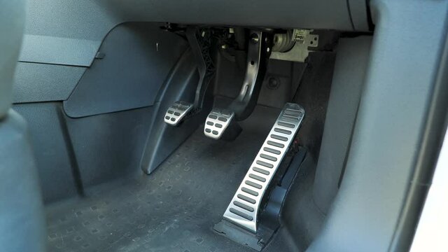 Car Pedals. Accelerator, Brake, And Clutch Pedals Of A Manual Gear Car. dolly shot