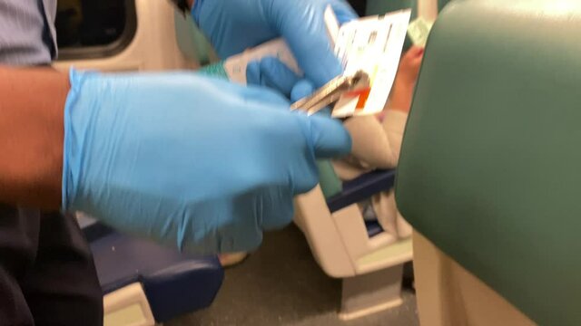 Train railway passager ticket verification stub indicator hole punched by the conductor wearing gloves