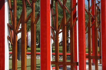 Fototapeta na wymiar Modern red fence with a natural background