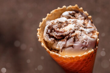 A cone of coconut-chocolate ice cream