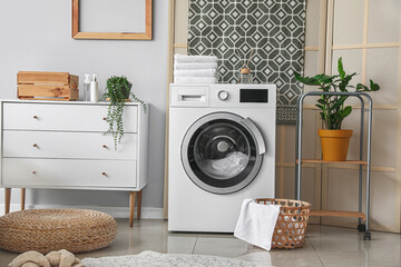 Interior of bathroom with modern washing machine
