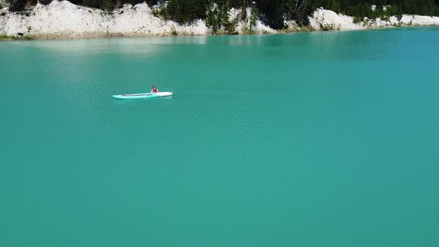 The girl bathes on a glanders. Warm summer day. Turquoise water. Aerial photography