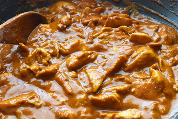 Indian chicken curry in a saucepan.