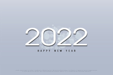 Fototapeta na wymiar Happy new year 2022 on a gray background.