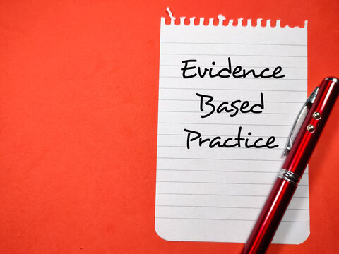 Medical Concept.Text Evidence Based Practice Writing On Notepaper With Pen On A Red Background.