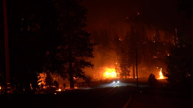 People Evacuate from fast moving wildfire