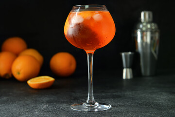Glass of tasty aperol spritz cocktail on dark background