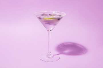 Glass of fresh cocktail with lavender on color background