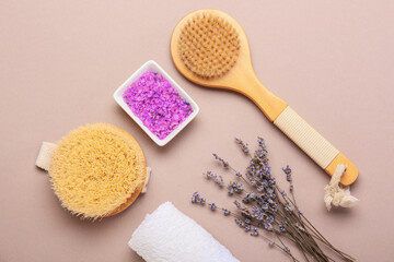 Fototapeta na wymiar Composition with bath supplies and lavender flowers on color background