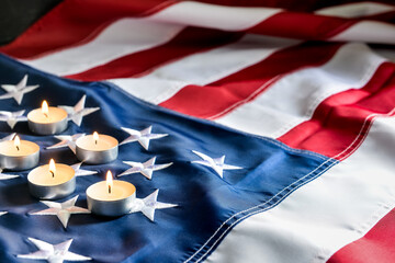 Burning candles on USA flag. National Day of Prayer and Remembrance for the Victims of the...