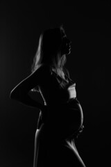 silhouette of Pregnant woman on a black background
