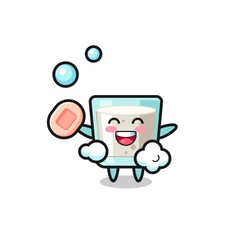 Obraz premium milk character is bathing while holding soap