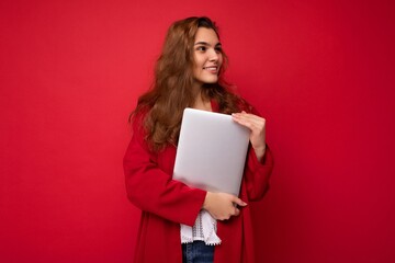 side profile photo of charming pretty young lady holding laptop isolated over wall background