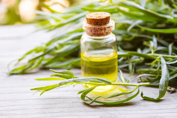 Essential oil of tarragon in a bottle. Selective focus.