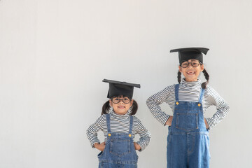 Siblings children girl graduation with cap