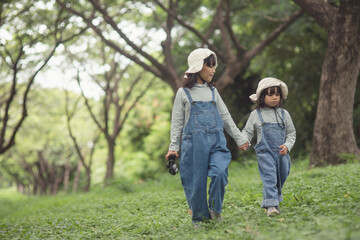 Fototapeta premium happy Asian girl getting ready for the journey with binoculars.