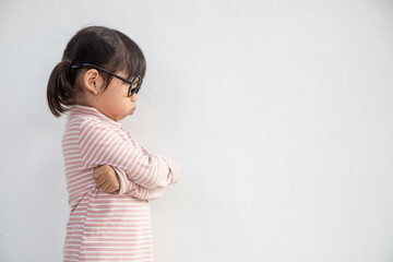 Obraz premium Angry little girl over white background, sign and gesture concept