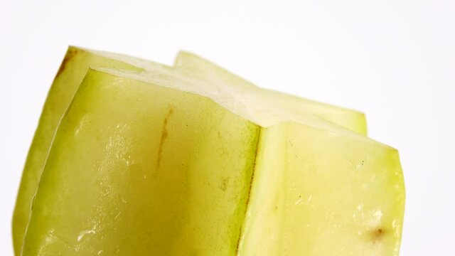 4K Organic star fruit carambola or star apple ( starfruit ) close-up rotates on a white background