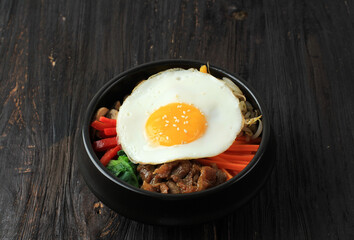 Traditional Korean dish: Bibimbap Rice with Mix Sautee Vegetables, Beef,  and Egg. Served with Red Spicy Bibimbap Sauce and Sesame Oil