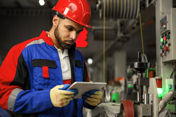 African american male manager in electric cable warehouse holding digital tablet