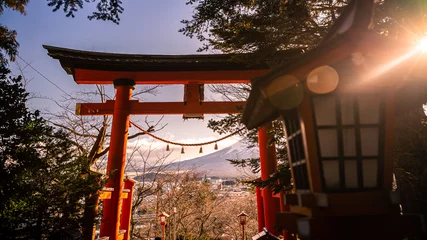 Zelfklevend Fotobehang A traditional red torii gate at sunset is a beautiful landmark travel place. © REC Stock Footage