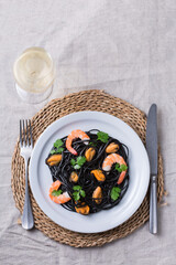 Black spaghetti pasta with seafood, shrimps, mussels and parsley