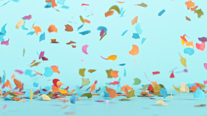 Naklejka na ściany i meble Color confetti falling on pastel blue background, macro shot.