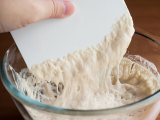 scraper mixing liquid bread dough starter