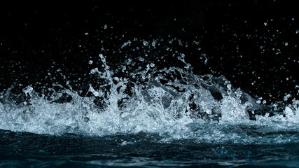 Freeze motion of water splash isolated on black background.