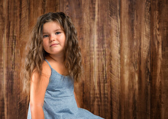 Fototapeta premium Portrait of child girl on wooden