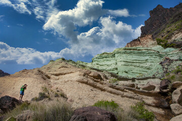 Fototapeta na wymiar Photographer at Parque Natural de Pilancones Gran Canaria Spain. Rocky landscape