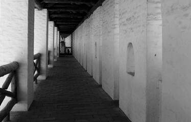 Black and white photo of a corridor with columns.
