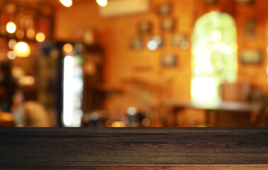 Empty wooden table in front of abstract blurred background of coffee shop . can be used for display or montage your products.Mock up for display of product