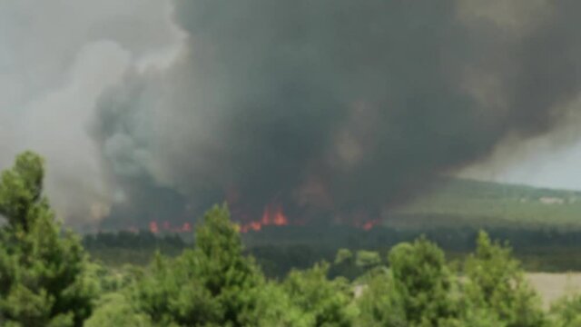 Big fire at Varimbombi, Athens, Greece, August 03, 2021. Blazing flames at mega fire, aerial firefighters attempting over big black smoke 120fps