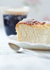 Simple yeast cake on bright background. Front view. Close up. Copy space.