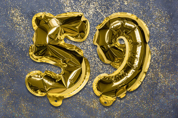 The number of the balloon made of golden foil, the number fifty-nine on a gray background with sequins. Birthday greeting card with inscription 59. Numerical digit, Celebration event, template.