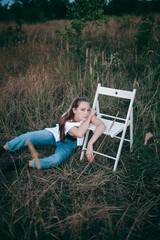 A girl in a field, lying on a blanket. He is resting a.nd enjoying his freedom. A beautiful girl is...
