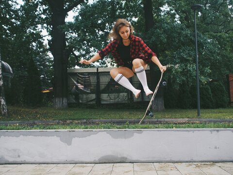 young woman riding a longboard, skateboard