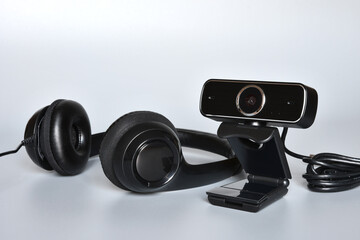 headphones with mic and a webcam, concept of smart working or online communications.