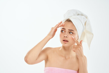 woman holding face skin problems bare shoulders close-up