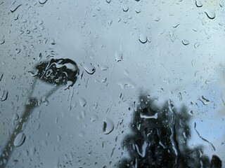 raindrops on glass and gray blurred background