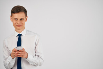 business man in shirt with tie phone in hands technology office