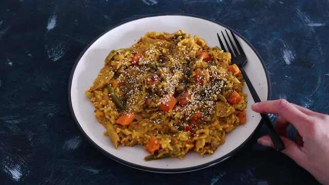 vegan curry rice with sweet potatoes beans and bell peppers and plantbased chicken, healthy plant-based food