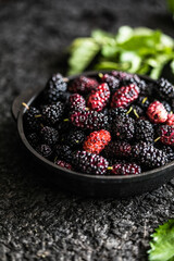 Fresh mulberries background. Various summer black fruits.